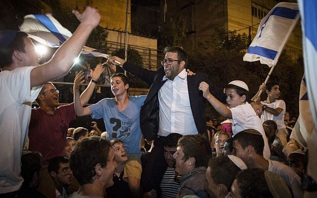 Likud Knesset Member Oren Hazan dances with demonstrators from the Samaria settler's council during a demonstration outside the prime minister's residence in Jerusalem, October 5, 2015 (Hadas Parush/Flash90)