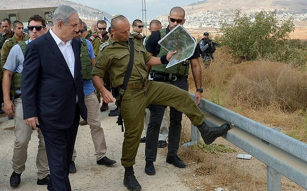 Prime Minister Benjamin Netanyahu (L) seen as he visits the Judea and Samaria area on October 6, 2015, Following recent terror attacks. (Amos Ben Gershom/GPO)