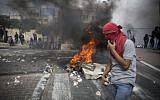 Palestinian youth holding rocks during clashes with Israeli police in the East Jerusalem neighborhood of Sur Baher on October 7, 2015. (Hadas Parush/Flash90)