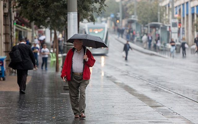 People hold umbrellas to protect themselves from the rain as they walk on Jaffa street, downtown Jerusalem, during the first rain of the upcoming winter, October 7, 2015. (Photo by Yonatan Sindel / Flash90) People hold umbrellas to protect themselves from the rain as they walk on Jaffa street, downtown Jerusalem, during the first rain of the upcoming winter, October 7, 2015. (Photo by Yonatan Sindel / Flash90)
