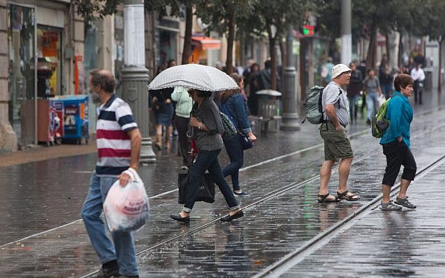 People hold umbrellas to protect themselves from the rain as they walk on Jaffa street, downtown Jerusalem, during the first rain of the upcoming winter, October 7, 2015. (Photo by Yonatan Sindel / Flash90) People hold umbrellas to protect themselves from the rain as they walk on Jaffa street, downtown Jerusalem, during the first rain of the upcoming winter, October 7, 2015. (Photo by Yonatan Sindel / Flash90)