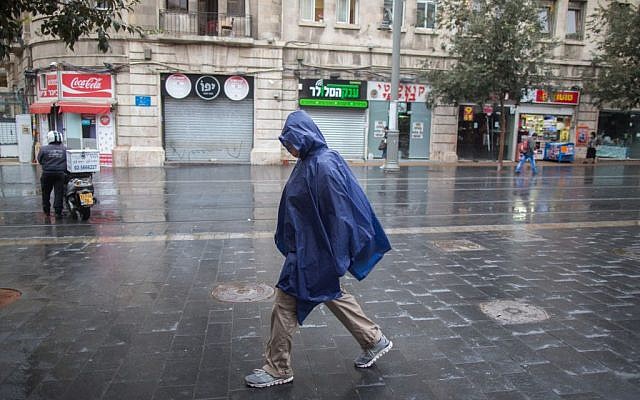 A man walks with a rain cover to protect himself from the rain as he walks on Jaffa street, downtown Jerusalem, during the first rain of the upcoming winter, October 7, 2015. (Photo by Yonatan Sindel / Flash90) A man walks with a rain cover to protect himself from the rain as he walks on Jaffa street, downtown Jerusalem, during the first rain of the upcoming winter, October 7, 2015. (Photo by Yonatan Sindel / Flash90)