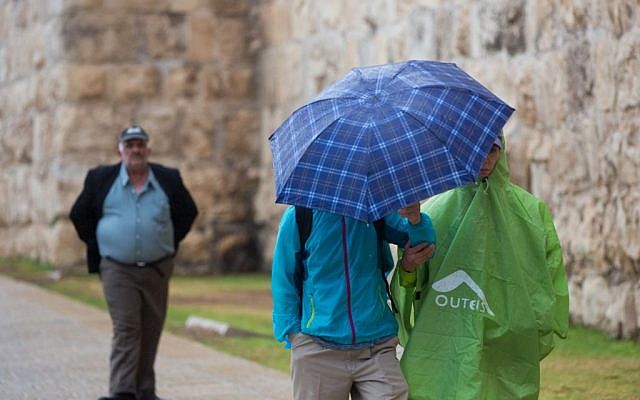 People hold umbrellas to protect themselves from the rain as they walk by Jaffa gate near the Tower of David in Jerusalem Old City during the first rain of the upcoming winter, October 7, 2015. (Photo by Yonatan Sindel / Flash90) People hold umbrellas to protect themselves from the rain as they walk by Jaffa gate near the Tower of David in Jerusalem Old City during the first rain of the upcoming winter, October 7, 2015. (Photo by Yonatan Sindel / Flash90)