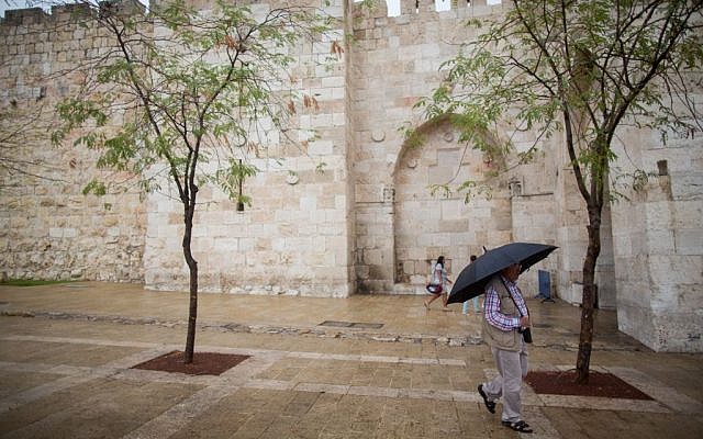 People hold umbrellas to protect themselves from the rain as they walk by Jaffa gate near the Tower of David in Jerusalem Old City during the first rain of the upcoming winter, October 7, 2015. (Photo by Yonatan Sindel / Flash90) People hold umbrellas to protect themselves from the rain as they walk by Jaffa gate near the Tower of David in Jerusalem Old City during the first rain of the upcoming winter, October 7, 2015. (Photo by Yonatan Sindel / Flash90)