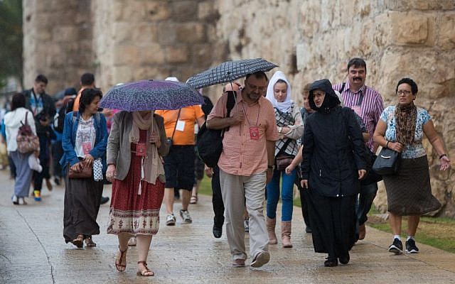 People walking by Jaffa Gate near the Tower of David in Jerusalem's Old City during the first rain of the season, October 7, 2015. (Yonatan Sindel/Flash90) People walking by Jaffa Gate near the Tower of David in Jerusalem's Old City during the first rain of the season, October 7, 2015. (Yonatan Sindel/Flash90)