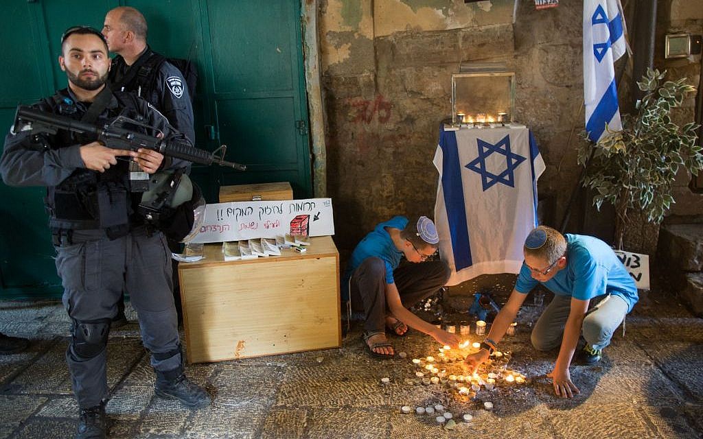 Jewish teenagers light candles in the shape of a star of David at the site of last week's stabbing attack in the Muslim Quarter in the Old City of Jerusalem, October 8, 2015 (Yonatan Sindel/Flash90) Jewish teenagers light candles in the shape of a star of David at the site of last week's stabbing attack in the Muslim Quarter in the Old City of Jerusalem, October 8, 2015 (Yonatan Sindel/Flash90)