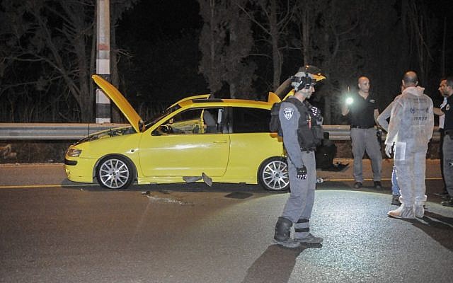 Police inspect the scene of the stabbing attack on route 65 near Kibbutz Gan Shmuel, October 11, 2015. (Flash90) Police inspect the scene of the stabbing attack on route 65 near Kibbutz Gan Shmuel, October 11, 2015. (Flash90)
