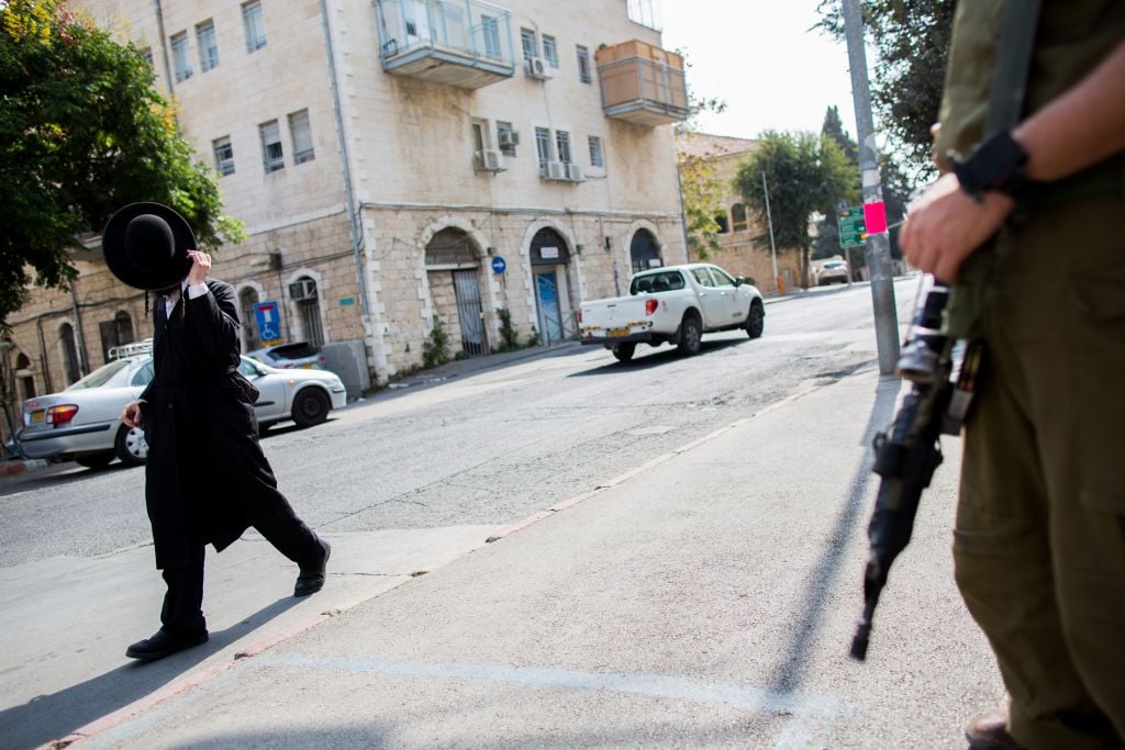 An Israeli soldier guards a bus station in the ultra Orthodox neighborhood of Mea Shearim after a recent spate of attacks (Yonatan Sindel/Flash 90) An Israeli soldier guards a bus station in the ultra Orthodox neighborhood of Mea Shearim after a recent spate of attacks (Yonatan Sindel/Flash 90)