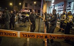 Israeli security forces seen near the body of a man who was shot dead on Wednesday night  after he apparently tried to grab a gun near the entrance to Jerusalem on October 21, 2015. (Hadas Parush/Flash90)