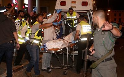 Zaka rescue personnel carry the body of a man shot dead by IDF soldiers in Jerusalem after he was mistaken for a terrorist, on October 21, 2015. (Hadas Parush/Flash90)