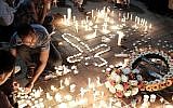 Memorial candles at a ceremony in Tel Aviv on October 21, 2015 to honor Haftom Zarhum, an Eritrean national who was killed in the Beersheba bus station attack. (Tomer Neuberg/Flash90)