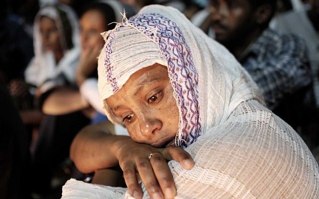 A woman mourns at a memorial in south Tel Aviv on October 21, 2015 for Haftom Zarhum, an Eritrean man who was mistaken for a terrorist. Zarhum was shot and then beaten by an angry mob. (Tomer Neuberg/Flash90) A woman mourns at a memorial in south Tel Aviv on October 21, 2015 for Haftom Zarhum, an Eritrean man who was mistaken for a terrorist. Zarhum was shot and then beaten by an angry mob. (Tomer Neuberg/Flash90)