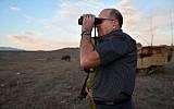 Then-defense minister Moshe Ya'alon looks through binoculars during a visit at an army exercise of the Armored Corps, in the Golan Heights on October 22, 2015. (Ariel Hermoni/Ministry of Defense)