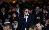 An ultra-Orthodox Jewish man mourns the death of Rabbi Haim Rothman in Har Nof, Jerusalem on October 24, 2015. (Yonatan Sindel/FLASH90)
