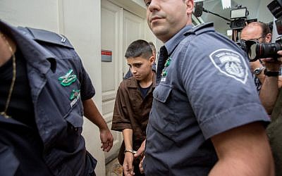 Palestinian 13-year-old Ahmed Manasra seen surrounded by guards at the Jerusalem Magistrate's Court on October 25, 2015. (Yonatan Sindel/Flash90)