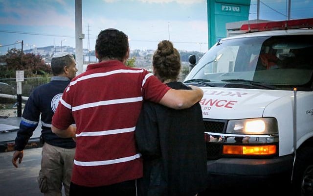 A woman is treated for shock after witnessing a terror attack outside Rami Levy supermarket in the Etzion bloc in the West Bank on October 28, 2015. (Gershon Elinsonl/Flash90)