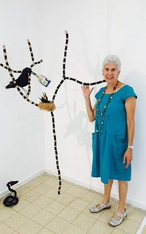 Navah de-Shalit and her crow made from netting perched on a tree formed of wine corks and inner tubes (Jessica Steinberg/Times of Israel) Navah de-Shalit and her crow made from netting perched on a tree formed of wine corks and inner tubes (Jessica Steinberg/Times of Israel)