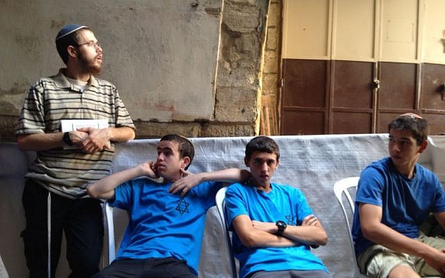 Jewish protesters lean on a police partition separating their tent from Hagai street in the Old City of Jerusalem, October 8, 2015 (Elhanan Miller/Times of Israel) Jewish protesters lean on a police partition separating their tent from Hagai Street in the Old City of Jerusalem, October 8, 2015 (Elhanan Miller/Times of Israel)