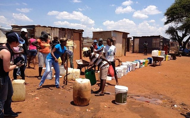 Lining up for water in an informal settlement outside of Johannesburg, South Africa (Courtesy) People lining up for water in an informal settlement outside of Johannesburg, South Africa (Courtesy)