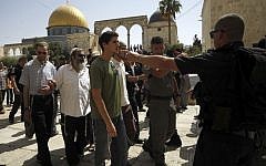 A group of religious Jews escorted by Israeli police visit the Temple Mount in Jerusalem, July 28, 2015. (AP/Mahmoud Illean)