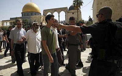 This Thursday, July 28, 2015 photo shows a group of religious Jews escorted by Israeli police at the Temple Mount in Jerusalem. (AP/Mahmoud Illean) 