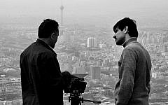 Undated file photo of Iranian filmmaker Keywan Karimi (left) and cameraman Arasto Givi (right),  during a scene of the film 'Writing on the City,' overlooking Tehran, Iran. (Keywan Karimi via AP)