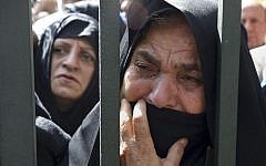 In this October 4, 2015, file photo, an Iranian mourner weeps during a funeral ceremony, attended by thousands of mourners in Tehran, Iran, for some of the pilgrims who were killed in a stampede during the hajj pilgrimage in Saudi Arabia in September 2015. (AP/Vahid Salemi, File)