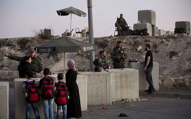 In this Thursday, Oct. 22, 2015 file photo, Israeli border police check Palestinians' ID cards at a checkpoint as they exit the Arab neighborhood of Issawiyeh in Jerusalem. (AP Photo/Oded Balilty) In this Thursday, Oct. 22, 2015 file photo, Israeli border police check Palestinians' ID cards at a checkpoint as they exit the Arab neighborhood of Issawiyeh in Jerusalem. (AP Photo/Oded Balilty)
