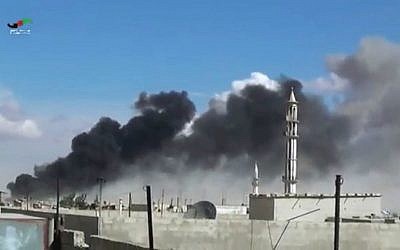 In this image made from video provided by Homs Media Center, smoke rises after Russian airstrikes by military jets in Talbiseh of the Homs province, western Syria, Wednesday, September 30, 2015. (Homs Media Center via AP)