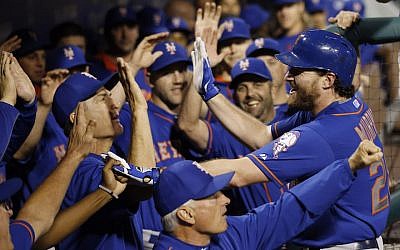 New York Mets' Daniel Murphy celebrates with teammates in the dugout after hitting a three-run home run off Philadelphia Phillies starting pitcher Alec Asher during the first inning of a baseball game, Wednesday, September 30, 2015, in Philadelphia (AP Photo/Matt Slocum)