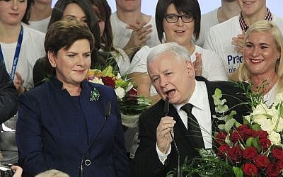 Conservative Law and Justice leader Jaroslaw Kaczynski and Justice candidate for the Prime Minister Beata Szydlo, left, deliver speeches at the party's headquarters in Warsaw, Poland, on Sunday, Oct. 25, 2015. The victory of Kaczynski's Eurosceptic party ends eight years in power of the pro-EU, pro-business Civic Platform which voters accuse of being conformist, detached and focused on power rather than on improving living standards in Poland.(AP Photo/Czarek Sokolowski)