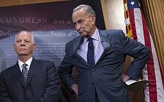 Sen. Charles Schumer, D-N.Y., right, accompanied by Sen. Ben Cardin, D-Md., listening during a news conference about legislation on Iran policy and Middle East security, Thursday, Oct. 1, 2015, on Capitol Hill in Washington (Evan Vucci/AP Images/JTA)