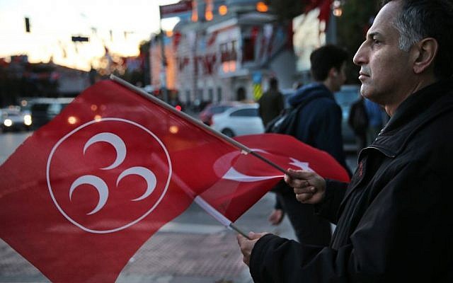 A supporter of Turkey's opposition Nationalist Action Party, (MHP), waves his party and nation flags, in Istanbul, Saturday, Oct. 31, 2015. (AP Photo/Hussein Malla) A supporter of Turkey's opposition Nationalist Action Party, (MHP), waves his party and nation flags, in Istanbul, Saturday, Oct. 31, 2015. (AP Photo/Hussein Malla)