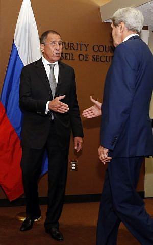 Russian Foreign Minister Sergey Lavrov, left, greets US Secretary of State John Kerry as he arrives for a meeting at UN headquarters, September 30, 2015. (AP/Jason DeCrow)