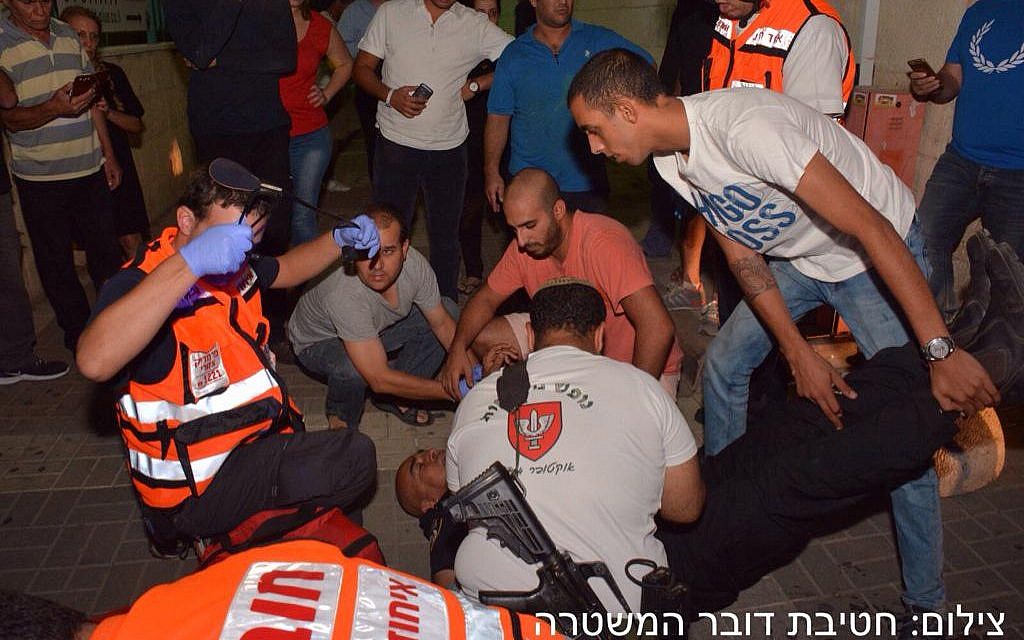 Medics working on a soldier who was stabbed in Afula on October 8, 2015. (Police spokesperson)
