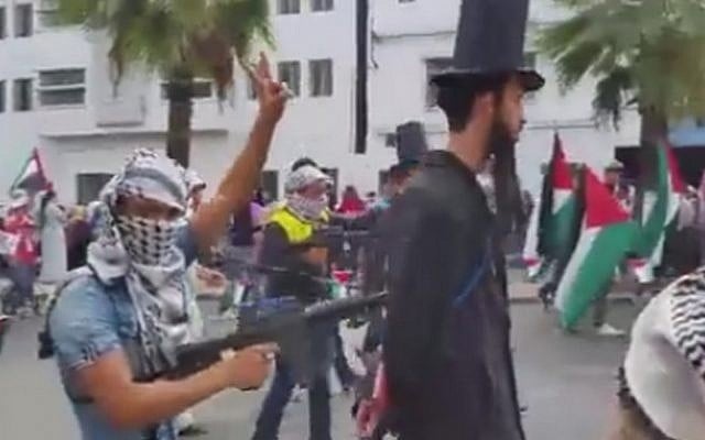 A still image from a video of a pro-Palestinian demonstration in Casablanca, Morocco, in which 'Jews' are held at gunpoint by keffiyeh-clad protesters, October 25, 2015. (screen capture: alyaexpress-news.com) A still image from a video of a pro-Palestinian demonstration in Casablanca, Morocco, in which 'Jews' are held at gunpoint by keffiyeh-clad protesters, October 25, 2015. (screen capture: alyaexpress-news.com)