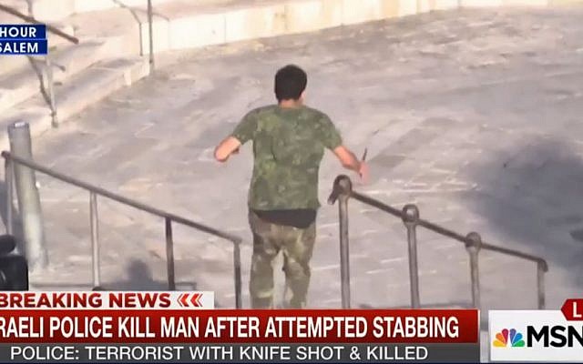 A man rushing at police with a knife in Jerusalem on October 14, 2015, caught by an MSNBC news crew. (Screen capture: MSNBC)