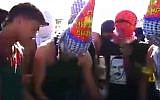 Palestinian demonstrators celebrating a birthday amid protests (screencap/DAM Palestine)