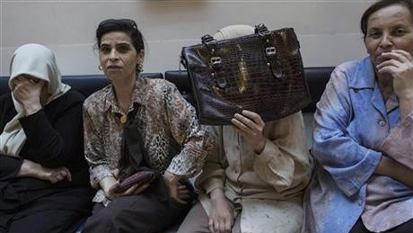 In this Monday, Oct. 12, 2015 photo, relatives of a 31-year-old Palestinian woman who critically wounded herself and lightly wounded a police officer on Sunday, when an explosive device went off in her vehicle in the West Bank, sit at the Hadassah Medical Center in Jerusalem (Tsafrir Abayov) In this Monday, Oct. 12, 2015 photo, relatives of a 31-year-old Palestinian woman who critically wounded herself and lightly wounded a police officer on Sunday, when an explosive device went off in her vehicle in the West Bank, sit at the Hadassah Medical Center in Jerusalem (AP Photo/Tsafrir Abayov)