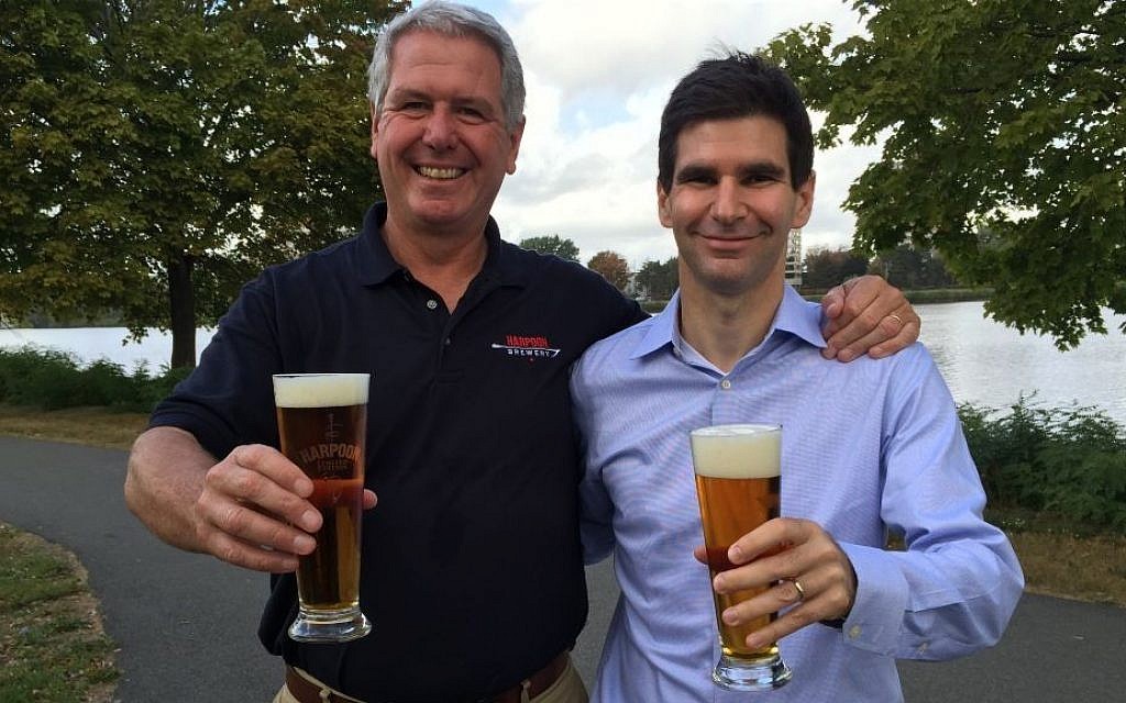 To craft its new Charles River Pale Ale beer, Boston's Harpoon Brewery partnered with Israeli-founded Desalitech to purify 300 gallons of the Charles River, appearing in the background of this September 2015 photo with Harpoon president Charlie Storey (left) and Desalitech CEO Nadav Efraty. (courtesy) To craft its new Charles River Pale Ale beer, Boston's Harpoon Brewery partnered with Israeli-founded Desalitech to purify 300 gallons of the Charles River, appearing in the background of this September 2015 photo with Harpoon president Charlie Storey (left) and Desalitech CEO Nadav Efraty. (courtesy)