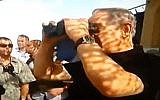 Prime Minister Benjamin Netanyahu looks through a covered pair of binoculars along the Gaza frontier, October 20, 2015 (YouTube screenshot)