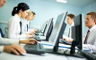 Workers on computers (computers image via Shutterstock)