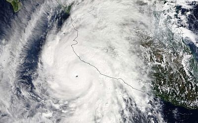 This satellite image taken at 1:30 p.m. EDT on Friday, October 23, 2015, and released by NASA, shows the eastern quadrant and pinhole eye of Hurricane Patricia moving towards southwestern Mexico. (Goddard MODIS Rapid Response Team/NASA via AP)