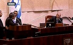 Immigration and Absorption Minister Ze'ev Elkin, left, surrounded by Knesset ushers, faces off with MK ands deputy speaker Ahmad Tibi, right, of the Joint (Arab) List during a heated exchange in the Knesset that ended with Elkin's removal from the plenum, October 21, 2015. (YouTube/99knesset)
