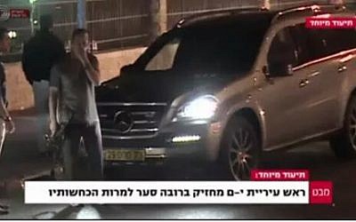 A screen capture from Channel 1 shows Mayor Nir Barkat with his gun.