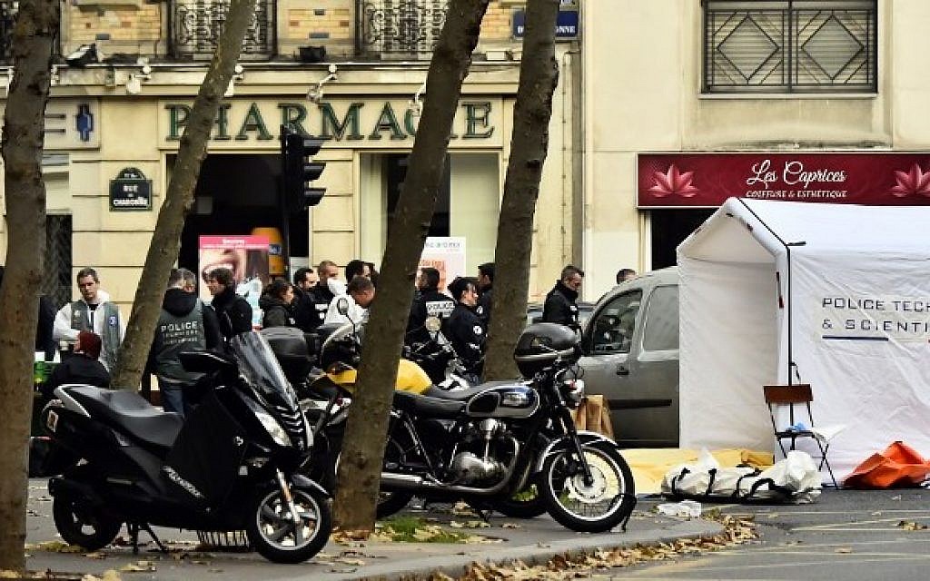 Forensic police are pictured at the Rue de Charonne in Paris on November 14, 2015, following a series of coordinated attacks in and around Paris late Friday which left more than 120 people dead.  (AFP PHOTO/LOIC VENANCE)