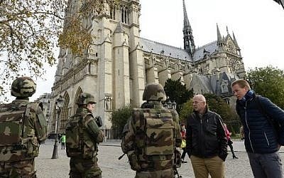French soldiers patrol in front of Notre Dame de Paris Cathedral in Paris on November 14, 2015, following a series of coordinated attacks in and around Paris late Friday that left at least 128 people dead. (AFP PHOTO/BERTRAND GUAY)