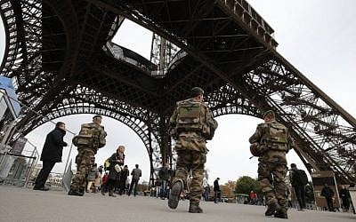 French soldiers patrol the area at the foot of the Eiffel Tower in Paris on November 14, 2015, following a series of coordinated attacks in and around Paris that left more than 120 people dead. (AFP/Francois Guillot)