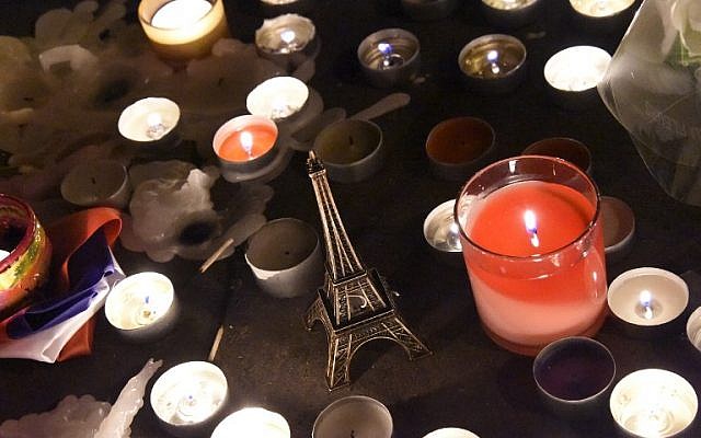 An Eiffel tower figurine is pictured among lit candles at a makeshift memorial in front of Le Carillon restaurant one of the sites of three deadly attacks in Paris, November 15, 2015. (AFP/DOMINIQUE FAGET) An Eiffel tower figurine is pictured among lit candles at a makeshift memorial in front of Le Carillon restaurant one of the sites of three deadly attacks in Paris, November 15, 2015. (AFP/DOMINIQUE FAGET)