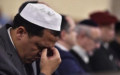 Imam of the Drancy Mosque, Hassene Chalghoumi, attends a ceremony at the Grande Synagogue de la Victoire in Paris on November 15, 2015 for the victims of a series of deadly attacks in the French capital two days earlier. (AFP PHOTO/LOIC VENANCE)
